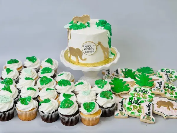 Jungle first birthday set with a gold animal cake for Camila, leaf cupcakes and Wild One cookies