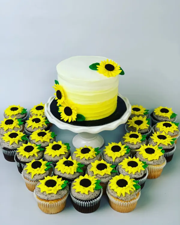 Yellow ombre buttercream cake with fondant sunflowers and cookies-and-cream sunflower cupcakes