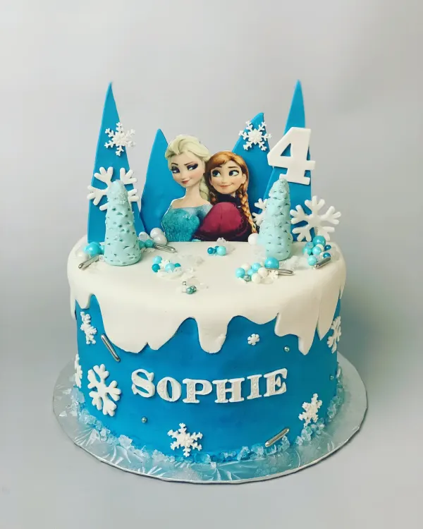 Frozen birthday cake with Elsa and Anna, blue ice shards, snowflakes and Sophie in fondant