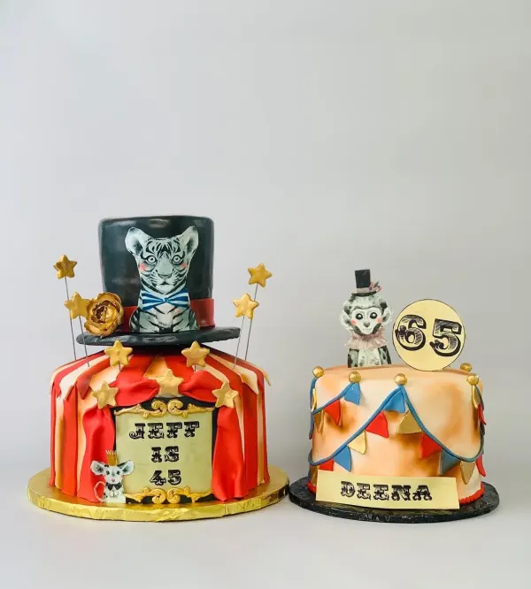 Two vintage circus cakes: a painted tiger in a top hat Jeff is 45 and a monkey-topped Deena 65