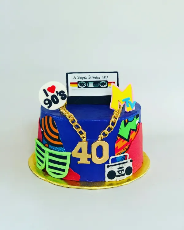 Blue 1990s themed 40th birthday cake with a mixtape topper, MTV logo, gold chain 40 and boombox