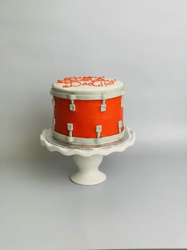Snare drum birthday cake in red and silver fondant with Happy Birthday Dad piped on the drumhead