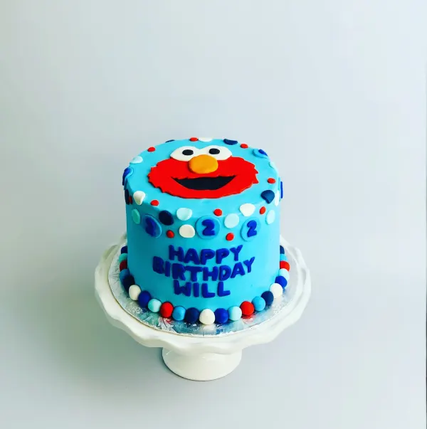 Blue Elmo second birthday cake with fondant dots and Happy Birthday Will in blue letters