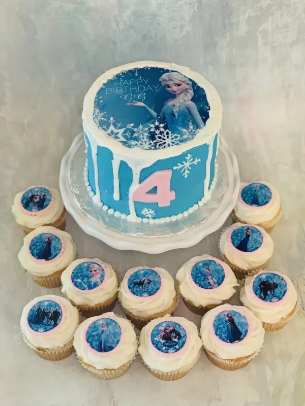 Frozen birthday cake with an Elsa image print reading Happy Birthday GG, a number 4 and matching cupcakes