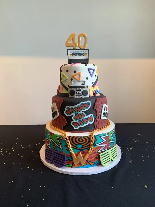 Four-tier 1990s themed 40th birthday cake with a cassette topper, boombox and MTV logo