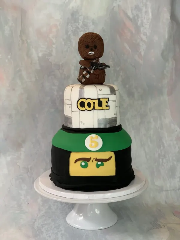 Three-tier cake with a Chewbacca topper, Cole in Star Wars lettering and a green Lego ninja face with 5