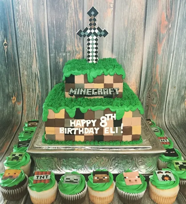 Two-tier Minecraft grass block cake with a pixel sword topper and Happy 8th Birthday Eli, plus cupcakes