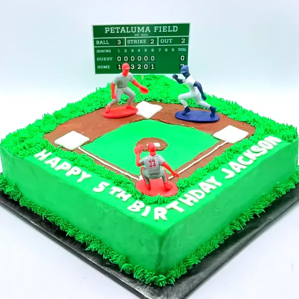 Square cake piped as a baseball field with a scoreboard, player figures and bases