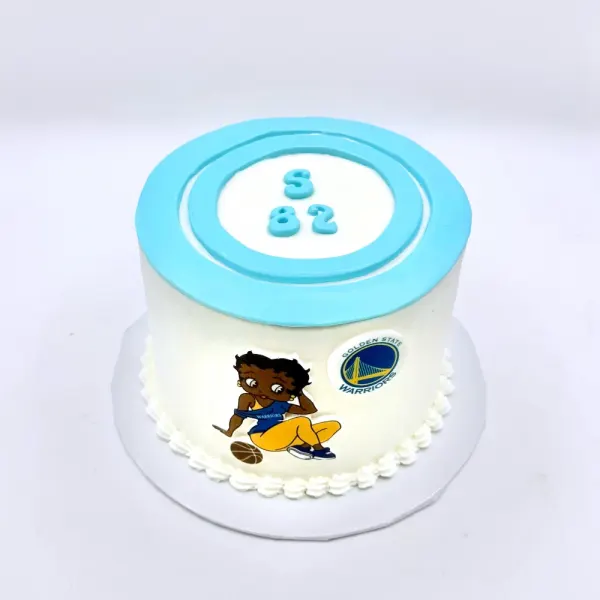 White cake with a blue top disc reading S 82, a piped border and a basketball team logo print