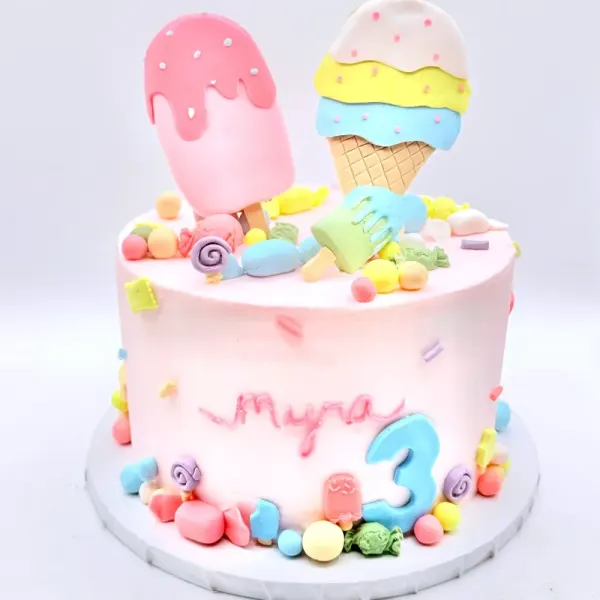 Pink cake for Myra's third birthday with fondant popsicle and ice cream toppers and candy trim