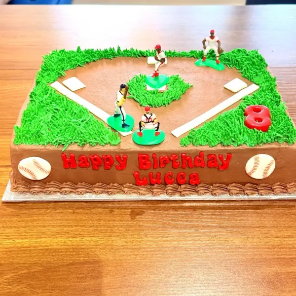Sheet cake piped as a baseball diamond with player figures, bases, baseballs and a number eight
