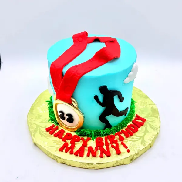 Turquoise cake with a gold race medal on a red ribbon and a black runner silhouette