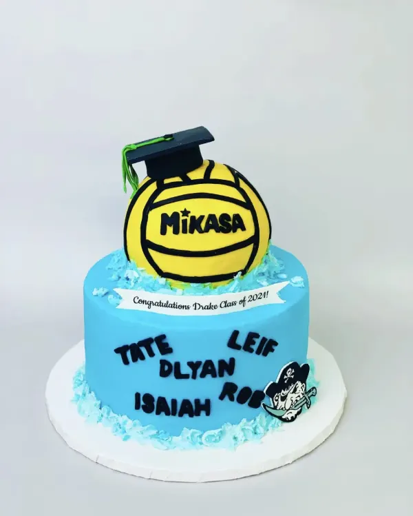 Blue cake with a water polo ball in a graduation cap and Congratulations Drake Class of 2021