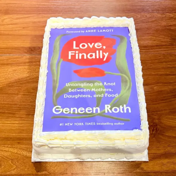 Sheet cake with an edible print of a book cover on top and a piped buttercream border