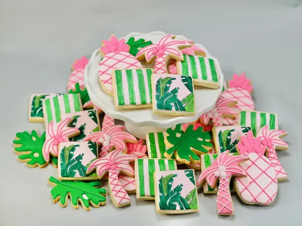 Tropical cookie set with pink pineapples, palm trees, green stripes and banana leaf panels