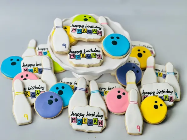 Bowling cookie set with pins, colored balls and plaques reading happy birthday Morgan