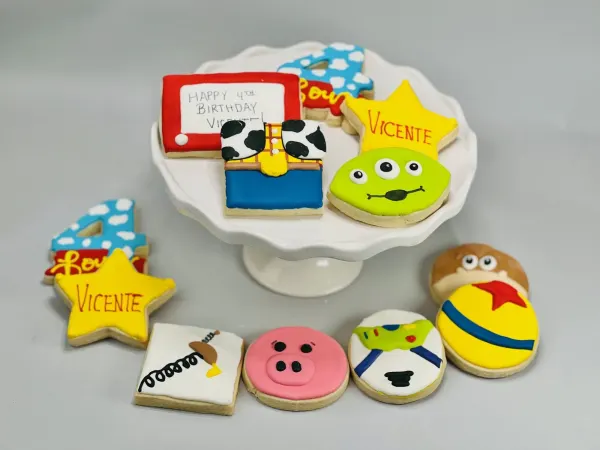 Toy Story cookie set with a green alien, Woody vest, sheriff star lettered Vicente and number 4