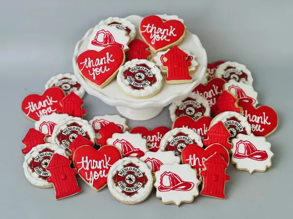 Menlo Park Fire District logo cookies with red thank you hearts, hydrants and helmets