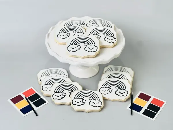 Paint your own cookies outlined with rainbows and clouds, with edible paint palettes and brushes
