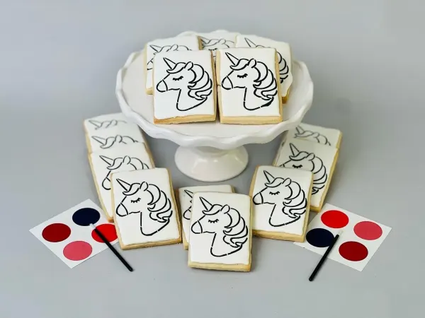 Paint your own unicorn cookies outlined in black with edible paint palettes and brushes