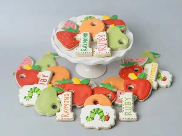 Caterpillar and fruit cookies with number 1 cookies lettered Raymond and Ruby