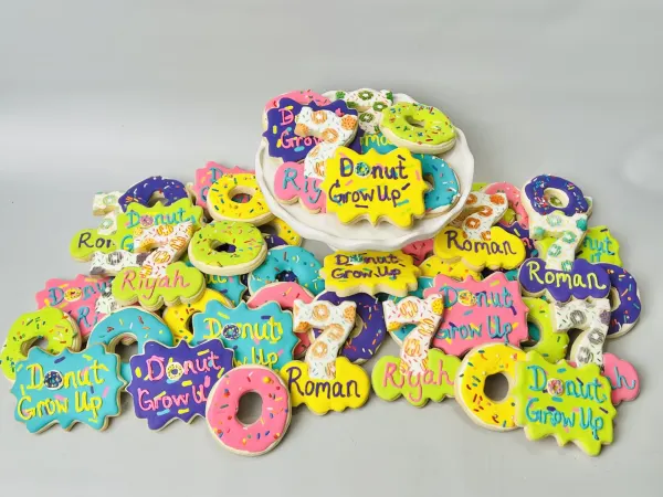 Neon donut cookie set reading Donut Grow Up with donuts, number 7 and the names Roman and Riyah