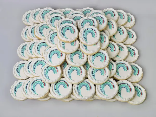 Round white cookies with a printed logo of concentric teal, blue and red arcs