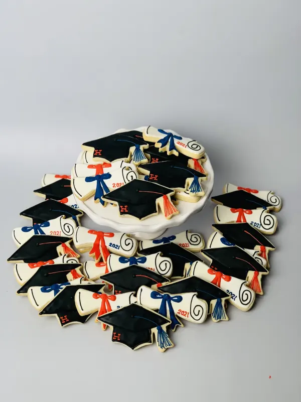 Graduation cookie set with black caps monogrammed H and 2021 diplomas tied with red and blue bows