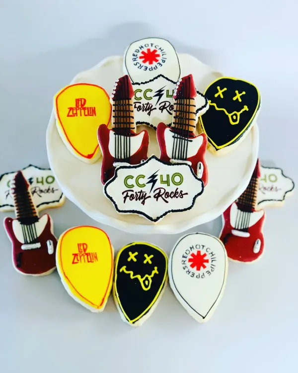 Rock-themed cookies with red electric guitars, band-logo guitar picks and CC 40 Forty Rocks plaques