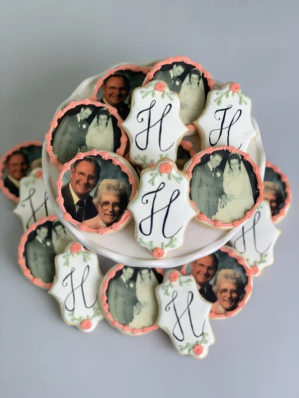Photo-print cookies with peach piped borders and white plaques monogrammed with a script H