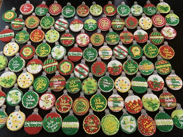 Christmas ornament cookies iced in red, green and white, each lettered We Value You