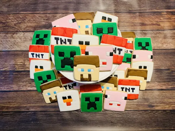 Minecraft-style square cookies with creeper faces, TNT blocks, pig and villager heads