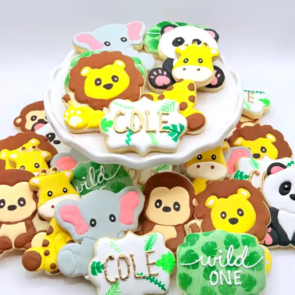 Safari animal cookies with a lion, elephant, giraffe and monkey, with Cole and wild one plaques