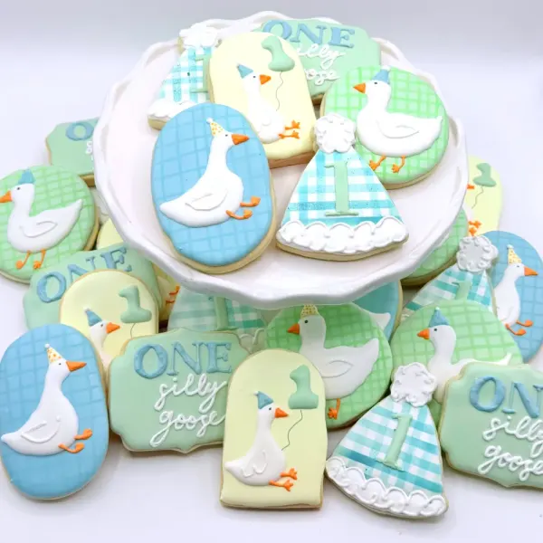 First birthday cookies with white geese, sage gingham, party hats and One Silly Goose plaques