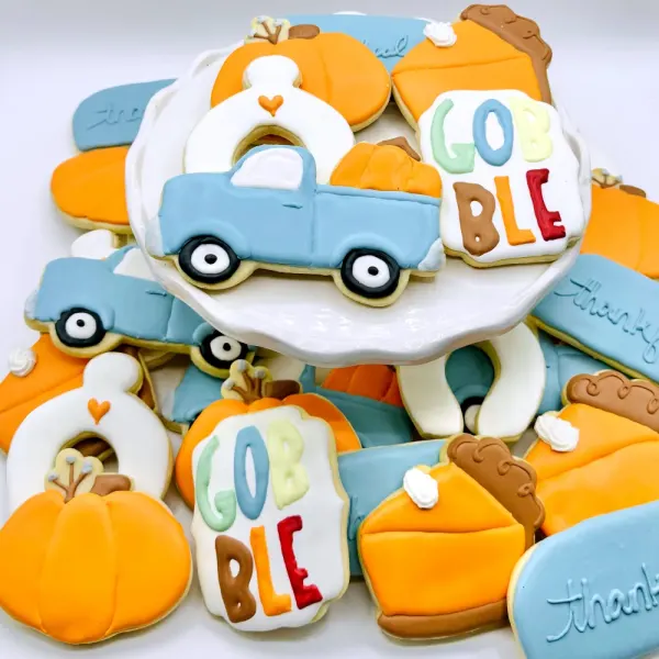 Thanksgiving cookies with a blue pickup truck, pumpkins, pie slices and Gobble lettering