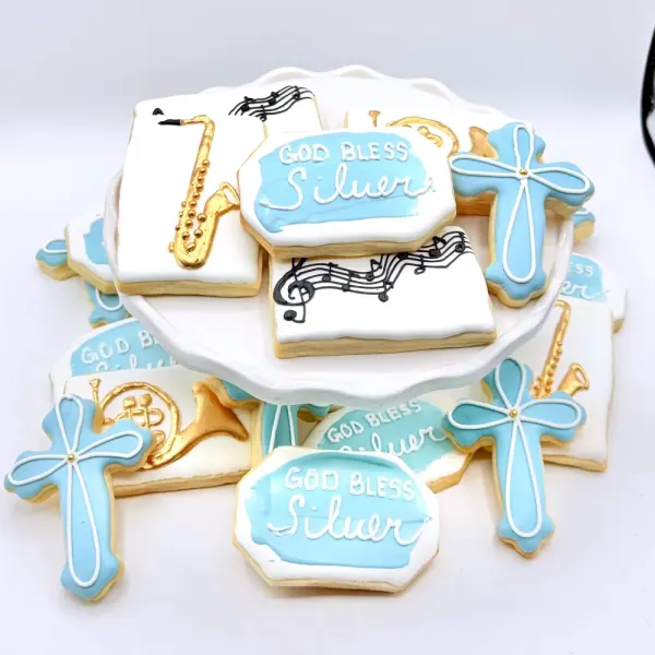 Blue and white cookies with crosses, a saxophone, music notes and God Bless Silver plaques