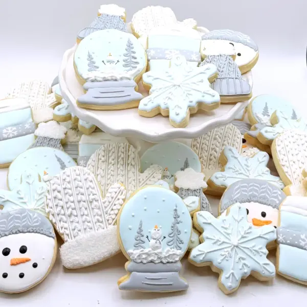 Winter cookies with snow globes, snowflakes, knit sweater patterns, mittens and snowmen