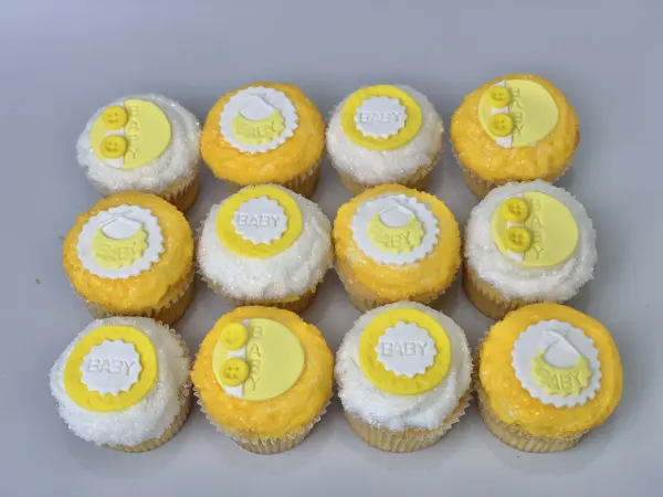 Cupcakes in yellow and white sanding sugar with fondant BABY plaques, baby bibs and buttons