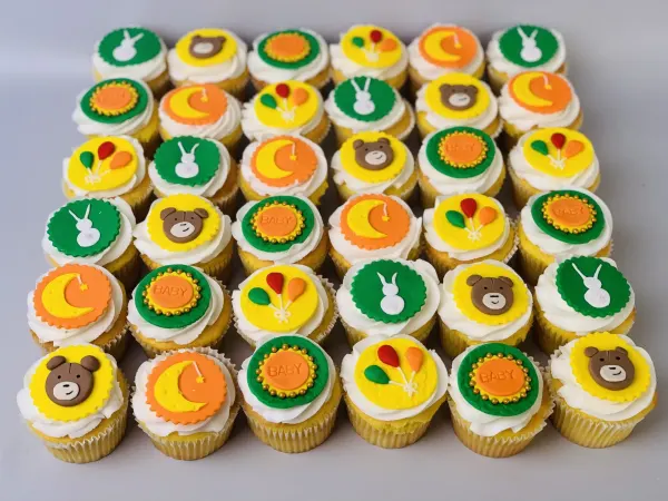 Cupcakes with fondant discs of bunnies, bears, moons, balloons and BABY plaques
