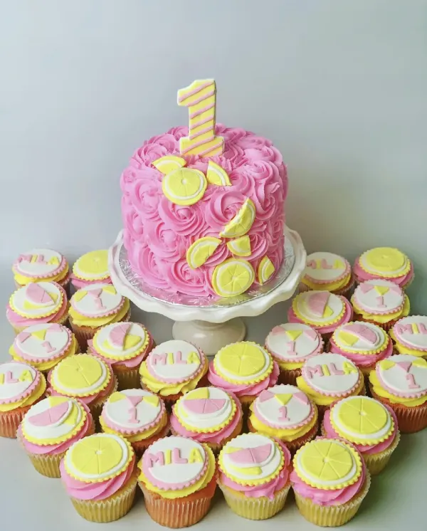 Pink rosette cake with fondant lemon slices and a striped number 1, with MILA and lemon toppers