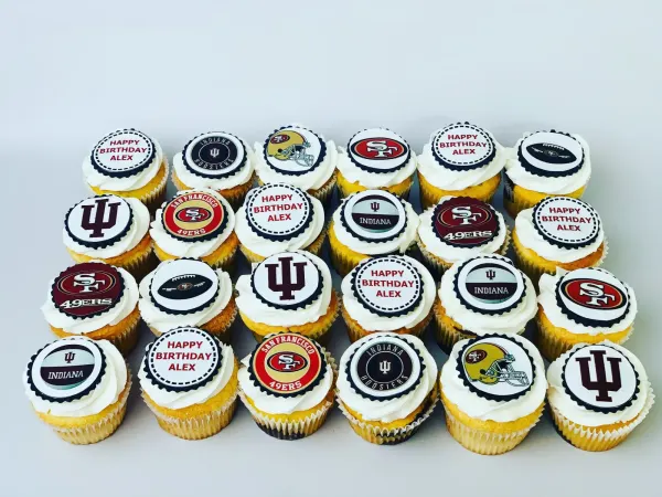 Cupcakes with edible prints of Indiana Hoosiers and SF 49ers logos and Happy Birthday Alex toppers