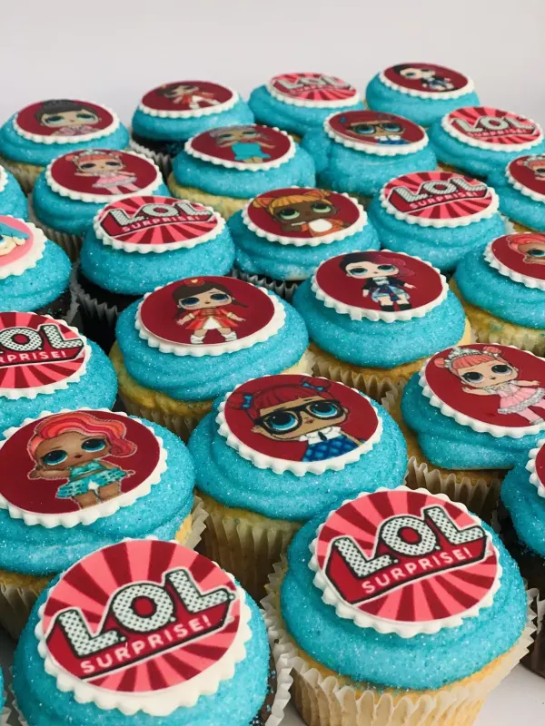Cupcakes in teal sanding sugar with printed L.O.L. Surprise logo and doll discs