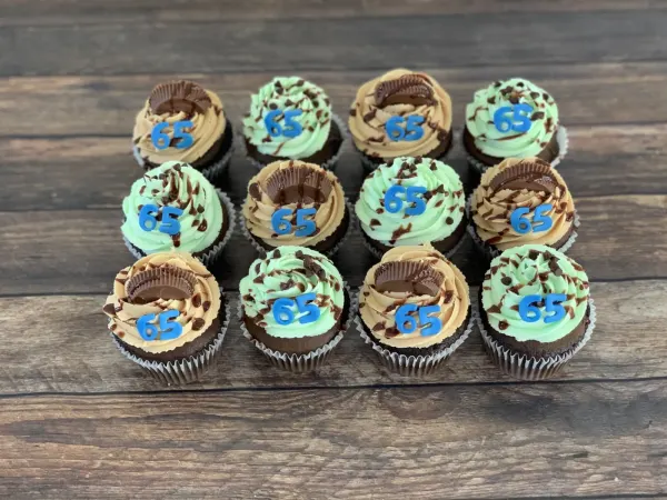 Chocolate cupcakes with peanut butter and mint frosting, peanut butter cups and blue fondant 65 numbers