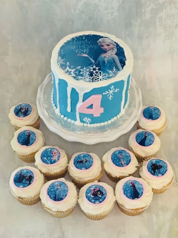 Blue fondant cake with an Elsa image and pink number 4, with matching Frozen character cupcakes