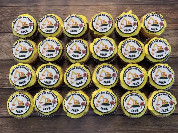 Yellow buttercream cupcakes with printed excavator discs reading HAPPY 2ND BIRTHDAY JACK