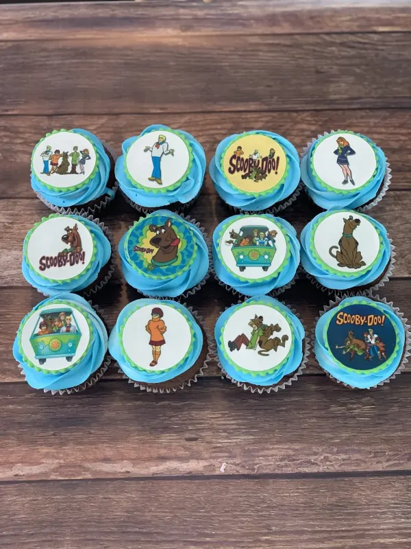 Cupcakes in blue buttercream with printed Scooby-Doo character and logo discs