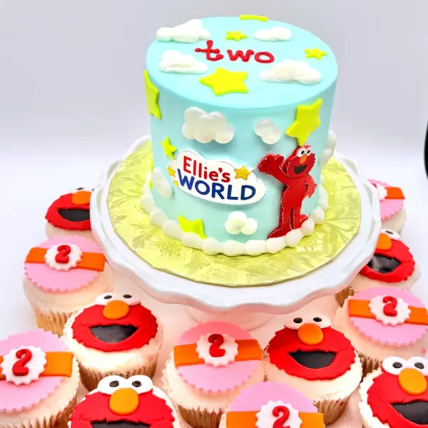 Sky blue cake with fondant stars, clouds and Elmo reading Ellie's World, with Elmo and number two cupcakes