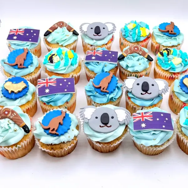 Australia cupcakes in blue buttercream with fondant koalas, kangaroos, boomerangs and flags